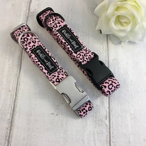 May include: Two pink and black leopard print dog collars with silver and black buckles. The collars are labeled "Guggle One Boot".