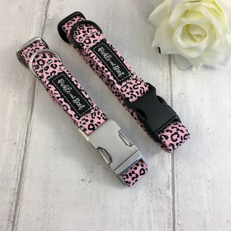 May include: Two pink and black leopard print dog collars with silver and black buckles. The collars are labeled "Guggle One Boot".
