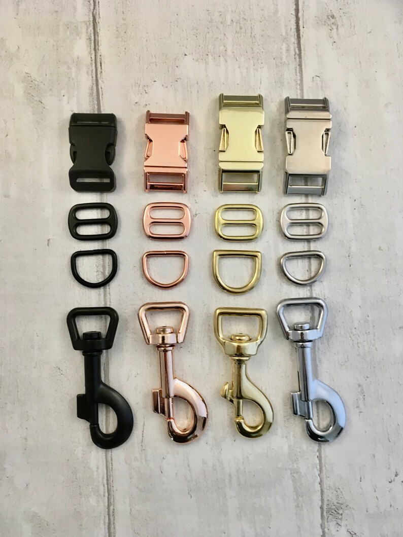 May include: An assortment of metal hardware components in black, rose gold, gold, and silver finishes. The image shows buckles, D-rings, and swivel snap hooks, suitable for crafting or pet-related items.