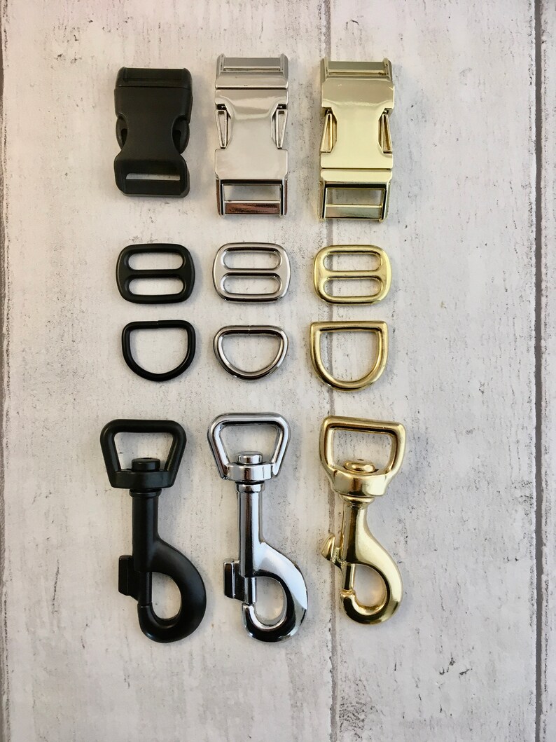 May include: Three sets of metal and plastic clasps and swivel hooks in black, silver, and gold. The clasps are for attaching leashes or collars to dog harnesses. The swivel hooks are for attaching leashes to collars.