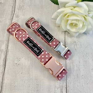May include: Two dog collars in a mauve polka dot design. One has rose gold hardware, the other silver. Each collar features a black label with the white text "Pickle and Boot".