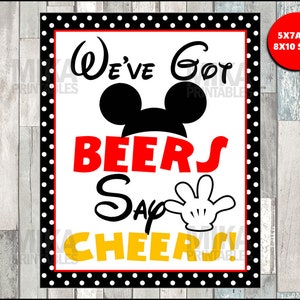 May include: A printable sign with a black and white polka dot border. The sign features a Mickey Mouse head with the text "We've Got Beers Say Cheers!" in red, yellow, and black.
