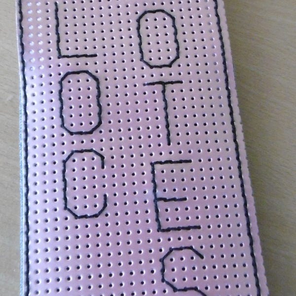 Embroidered notepad in pink perforated lacquered vinyl