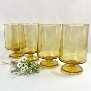 May include: A set of three ceramic mugs with a speckled, matte finish. The mugs are in shades of cream, light gray, and dark gray. Each mug has a simple, minimalist design, perfect for coffee or tea.