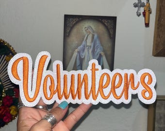 Volunteers glitter iron on patch