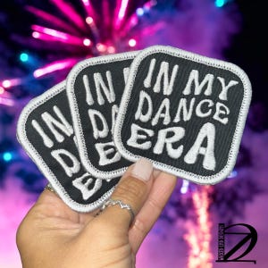 May include: Three black iron-on patches with white embroidered text that reads "In My Dance Era".