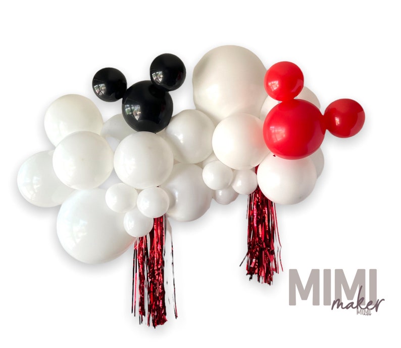 May include: A balloon garland with white, black, and red balloons. The garland features two Mickey Mouse ears, one black and one red. The garland is decorated with red and silver streamers.
