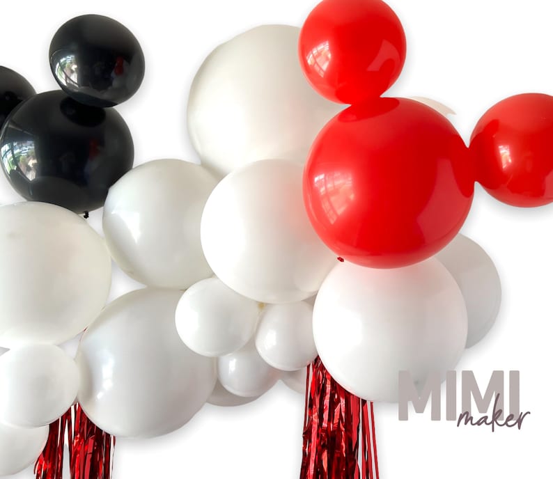 May include: A balloon arch featuring red, black, and white balloons arranged in the shape of Mickey Mouse ears. The arch is decorated with red streamers.