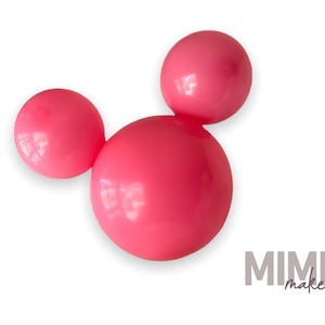May include: Three bright pink spheres arranged in a Mickey Mouse-like shape. The spheres are smooth and glossy, with a slight reflection. The image is set against a clean white background. The text "MIMI maker" is in the bottom right corner.