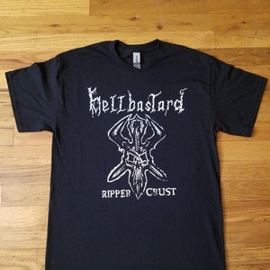 May include: Black t-shirt with a white graphic print of a skull with horns and the text "Hellbastard Ripper Crust".
