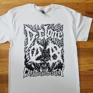 May include: White t-shirt with a black and white graphic print of a skull with flames and the text "Deluge" and "Creation and Destroy".