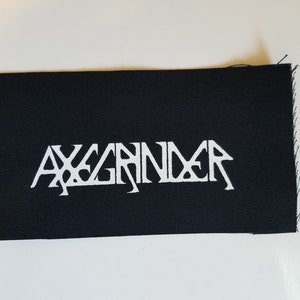 May include: Black fabric patch with white lettering that reads "AXGRINDER".