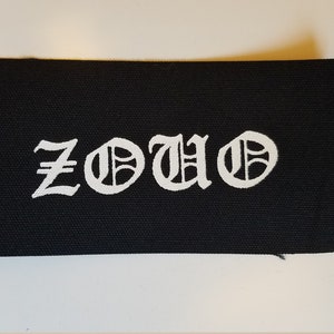 May include: Black fabric patch with the word "ZOUO" in white, stylized lettering.