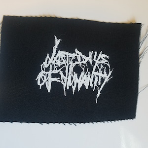 May include: A black fabric patch with white embroidered text that reads "Last Days Of Humanity".