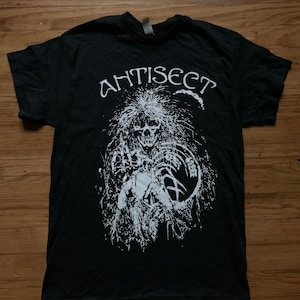 May include: Black t-shirt with a white graphic print of a skull with a crown of thorns and the word "ANTISECT" above it.
