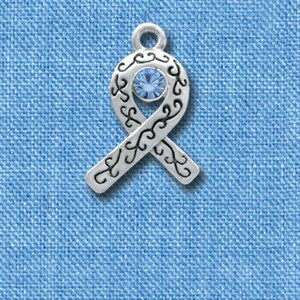 May include: A silver charm in the shape of a blue ribbon with a light blue rhinestone in the center.
