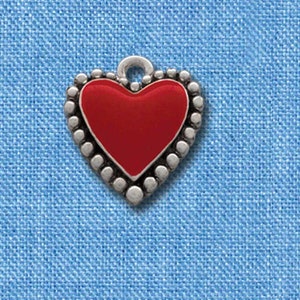 May include: A red heart charm with a silver border and a silver loop for attaching to a necklace or bracelet. The charm is about 1 inch in diameter.