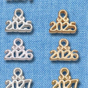 May include: A set of eight silver and gold charms with the years 2024 through 2028. The charms are arranged in two rows of four, with the silver charms on the top row and the gold charms on the bottom row. Each charm is about 1.5 inches tall.