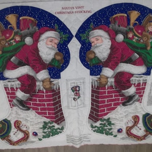 May include: Christmas stocking fabric with a design of Santa Claus descending a brick chimney. Santa is dressed in a red suit and carries a green sack of toys. The text "SANTA'S VISIT CHRISTMAS STOCKING" is printed at the top.