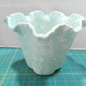 May include: A light green ceramic vase with a ruffled rim and a speckled white pattern. The vase has a wide opening and a rounded base. The date and time "01-19-2025 11:58:44" is visible in the top left corner.