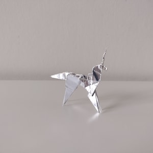 May include: A silver origami unicorn, a traditional Japanese paper folding art form.