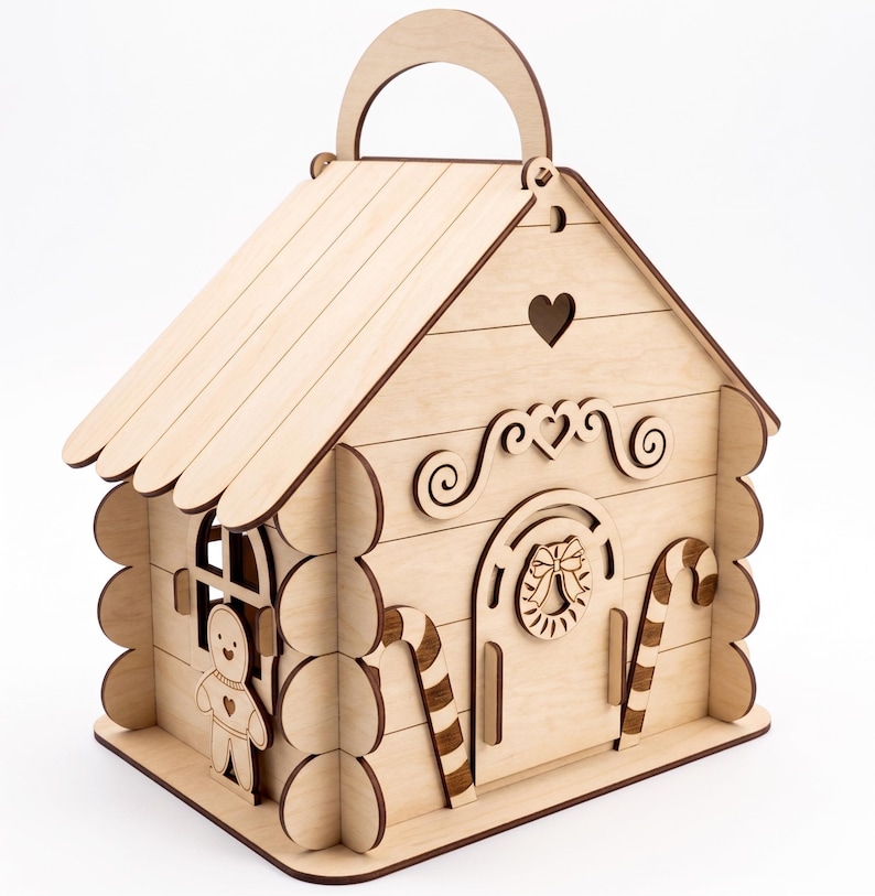 A wooden toy house with a gingerbread man figure on the side.