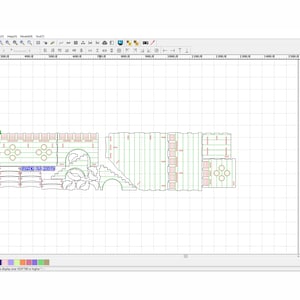 May include: A computer screen displaying a laser cutting design program. The design is for a multi-level structure with intricate details. The design is shown in green and red lines on a grid background. The program has a toolbar with various options for editing and controlling the laser cutter.