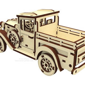 May include: A wooden model kit of a vintage pickup truck. The truck is light brown with dark brown accents. The truck has a flatbed and a cab with a steering wheel and a windshield. The truck is on a white background.