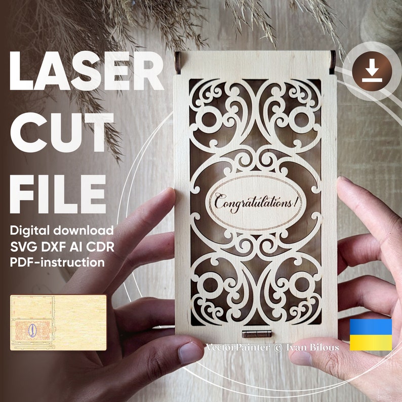 May include: A laser cut wooden box with a decorative design and the word "Congratulations!" inside. The box is held in a person's hands. The image includes the text "Vector Painter &copy; Ivan Bilous".
