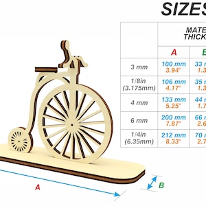May include: A wooden model of a vintage bicycle with a large front wheel and a smaller back wheel. The model is available in different sizes, with the material thickness ranging from 3 mm to 6.35 mm. The dimensions of the model are shown in millimeters and inches.
