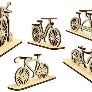 May include: Five wooden bicycle models on separate bases. The bicycles are in various styles, including a penny-farthing, a tandem, and a modern road bike.