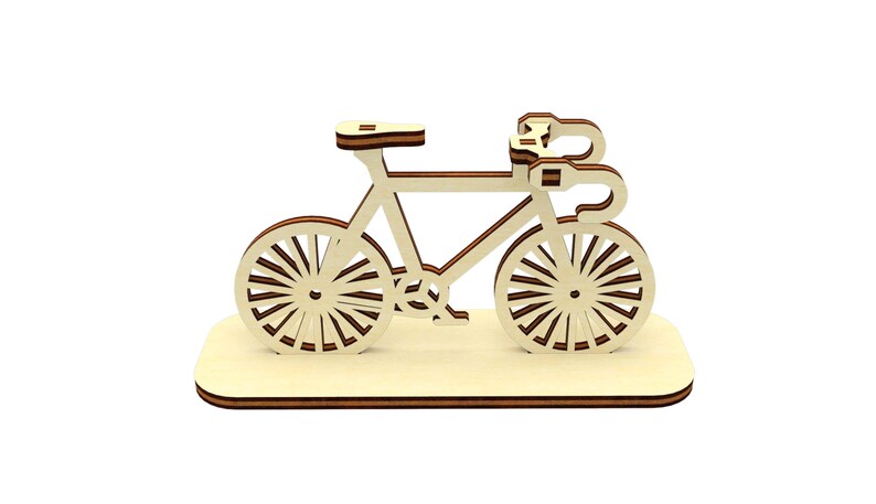 May include: A wooden model of a bicycle with a brown base. The bicycle is made of light wood and has a simple design.