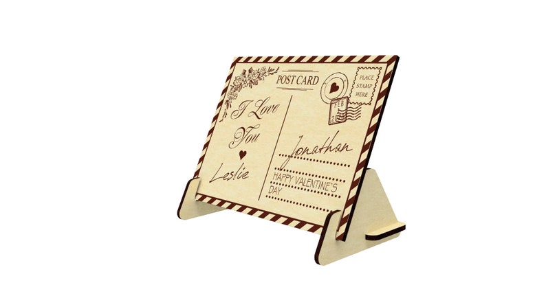 May include: A wooden postcard with a vintage design featuring the text "I Love You" and "Happy Valentine's Day". The postcard is standing on a wooden easel.