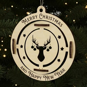 Close-up of laser cut reindeer ornament with Merry Christmas and Happy New Year text – plywood holiday decoration for cutting machines