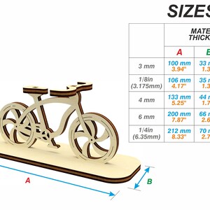 May include: A wooden model of a bicycle with a stand. The model is available in different sizes depending on the material thickness. The sizes are listed in a table with measurements in millimeters and inches.