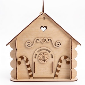 A wooden cabin-like structure with a heart-shaped cutout on the roof, decorated with candy canes and a wreath.
