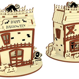 two wooden Halloween-themed houses, each with a spooky design and decorations. The houses are decorated with bats, skulls, and other Halloween-related elements, creating a festive and spooky atmosphere.