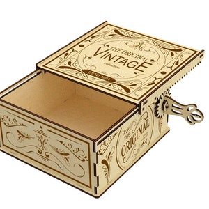 May include: A wooden box with a hinged lid and a key wind-up mechanism. The box is decorated with a brown floral design and the text "The Original Vintage Collection Estd 1904".