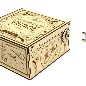 May include: A wooden music box with a key wind-up mechanism. The box is decorated with a brown and cream floral design and the text "The Original Vintage Established 1884".
