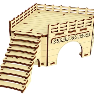 May include: Wooden guinea pig house with a ramp and a platform. The house has a rounded archway entrance and the words "Guinea Pig House" are printed on the front.