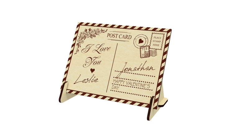 May include: A wooden postcard with a vintage design. The postcard says "I Love You" and "Happy Valentine's Day". The postcard is addressed to "Jonathan" from "Leslie".