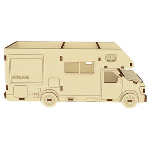 May include: A wooden model of a camper van with the word "OUTDOOR" printed on the side. The model is made of light brown wood and has brown lines for detail. The camper van has a pop-up roof and a window on the side.