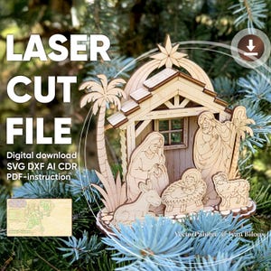 May include: A laser-cut wooden nativity scene, depicting Mary, Joseph, baby Jesus, a donkey, and a sheep. The design includes a star, palm trees, and a stable. The text "LASER CUT FILE" is visible. The digital download includes SVG, DXF, AI, CDR, and PDF instructions.