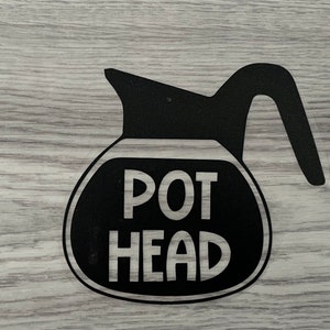 May include: Black and white silhouette of a coffee pot with the text "POT HEAD" on the front.