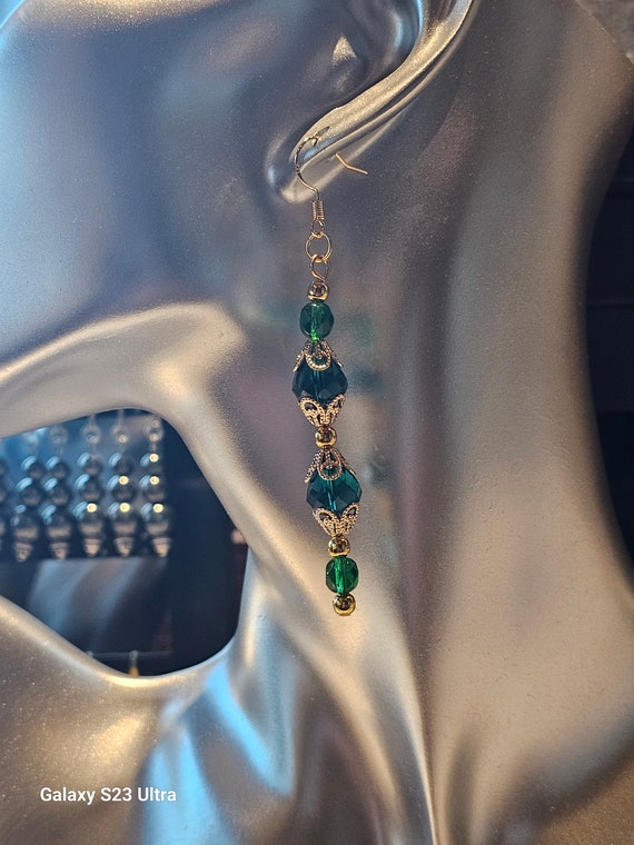 Emerald crystals encased in gold filigree earrings about a 3 inch drop