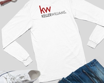 May include: White long-sleeve shirt with the Keller Williams logo in red and gray on the back. The shirt is paired with blue jeans, white sneakers, and a brown leather watch with a silver watch face.