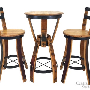 May include: A set of two wooden barrel bar stools with black metal accents and a round wooden barrel table with a black metal base. The table and stools are made from reclaimed wine barrels.