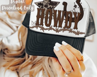 May include: A white trucker hat with a brown "HOWDY" text, a brown horseshoe, and a brown star with a white and brown spotted pattern. The hat has a black mesh back.