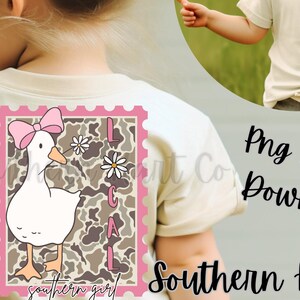 May include: A cream t-shirt with a cartoon duck wearing a pink bow, inside a pink-edged stamp design. The stamp includes the word "LOCAL" and the phrase "southern girl". A smaller image shows a daisy graphic.