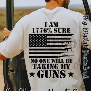 May include: White t-shirt with a graphic design featuring an American flag with rifles and the text "I AM 1776% SURE, NO ONE WILL BE TAKING MY GUNS." The shirt also includes the text "Southern Hart Co."